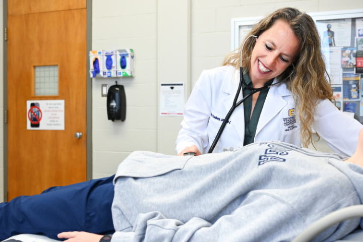 A student is examined at University Health Services during an office visit. 