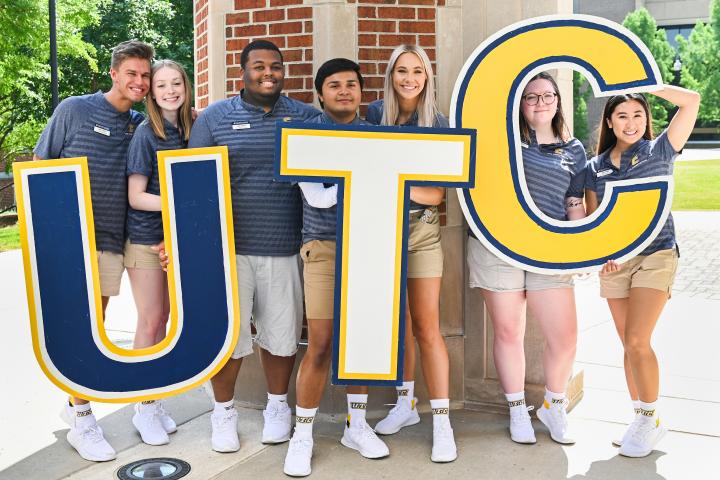 Orientation leaders holding up UTC letters