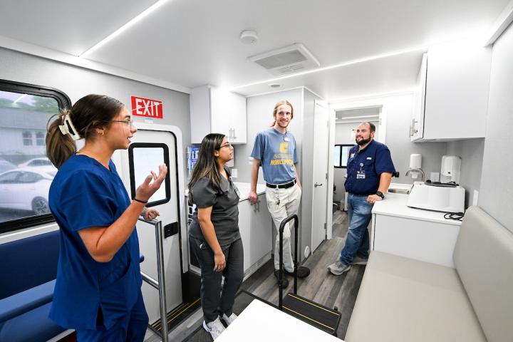 MobileMOC staff showing students the mobile clinic