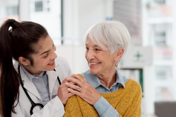 A female CNA takes care of elderly patient