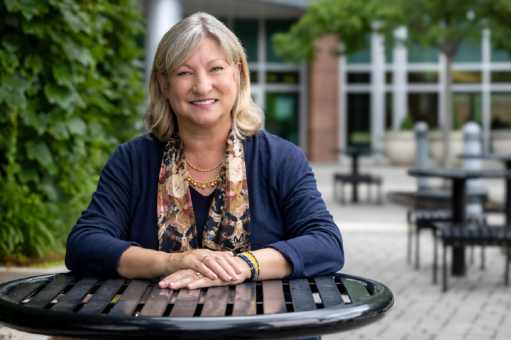 Chancellor Bruce smiling on campus outdoor seating
