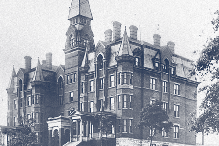 Historic photo of UTC's original Victorian-era main building with a tall spire