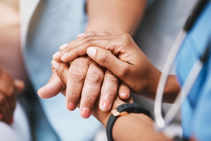 A phlebotomist supports anxious patient