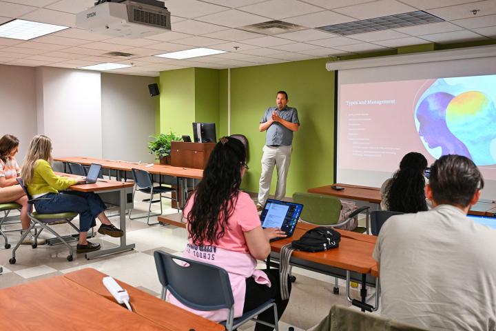 Dr. Jason Peter lectures to students during a nursing class.