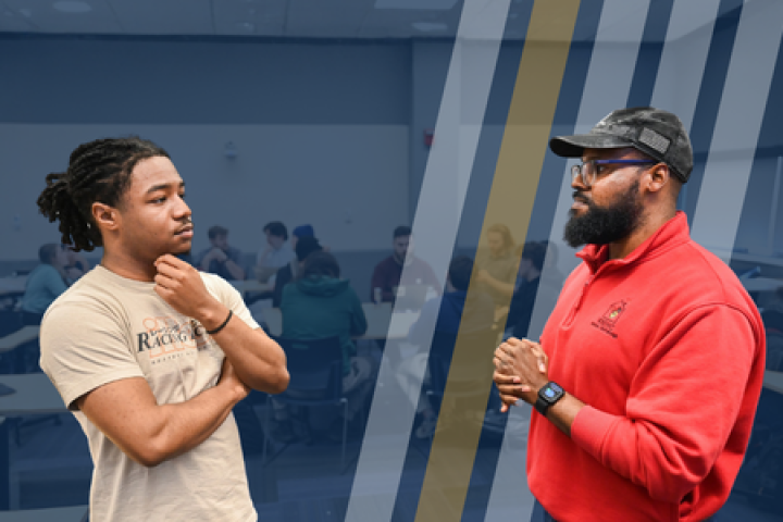 An instructor speaks to a student during a class at RCOB. 