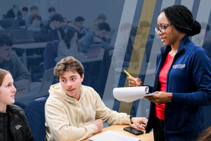 UTC professor Leanora Brown works with 2 students in a macroeconomics course.