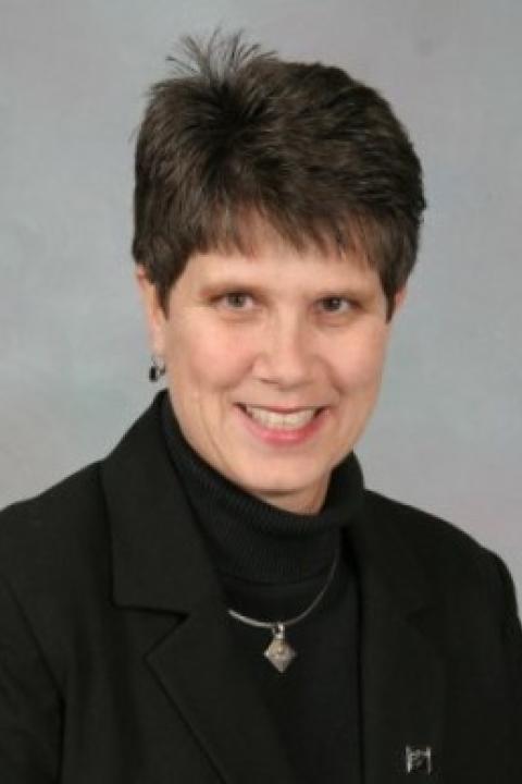 An image of Teresa Elliot holding a clarinet