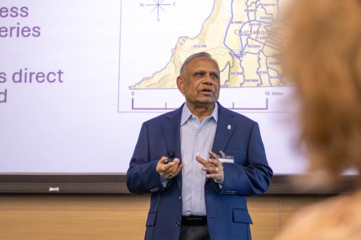 Dr. Hemant Jain speak with attendees during the JHFRC Data Summit.