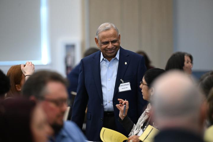 Dr. Hemant Jain speak with attendees during the JHFRC Data Summit.