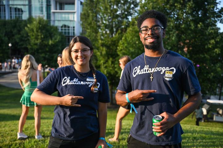 UTC students wearing blue shirts and holding up the Power C hand gesture