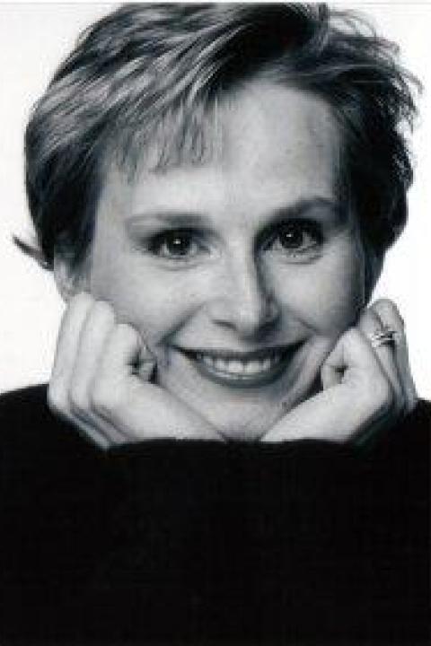 Woman holding hands to face smiling