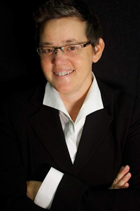 Woman standing against black background