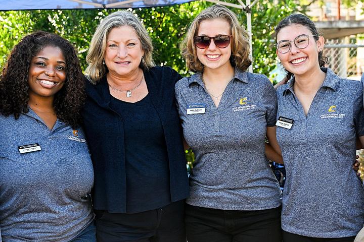 3 female staff with Chancelor Lori Bruce