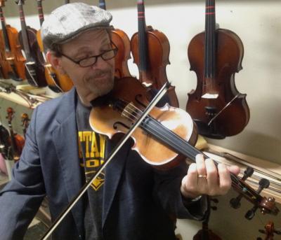 Tom Morley plays a violin