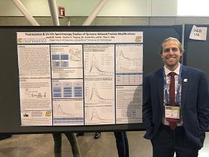 Jacob Ewald ACS 2018 Student stands in front of poster presentation