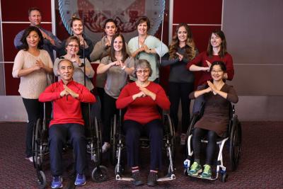 Tai Chi participants sitting and standing for picture