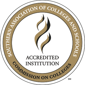 SACSCOC Logo, which is a circle with the words "Southern Association of Colleges and Schools" on a ring next to "Commission on Colleges" on the same ring. Inside the ring printed is "Accredited Institution"