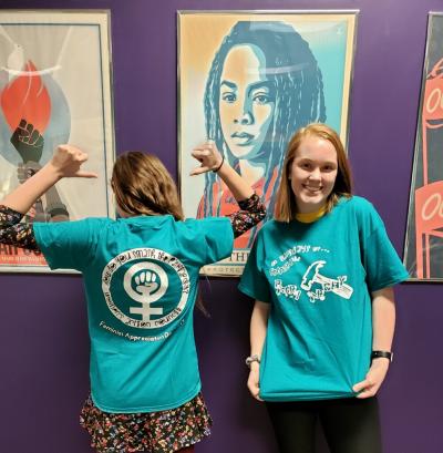 Two women sporting WAC t-shirts