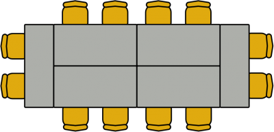 Several tables placed together in a rectangle with chairs around them
