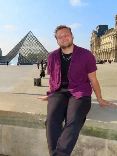 Landon posing in front of the Leuvre in Paris