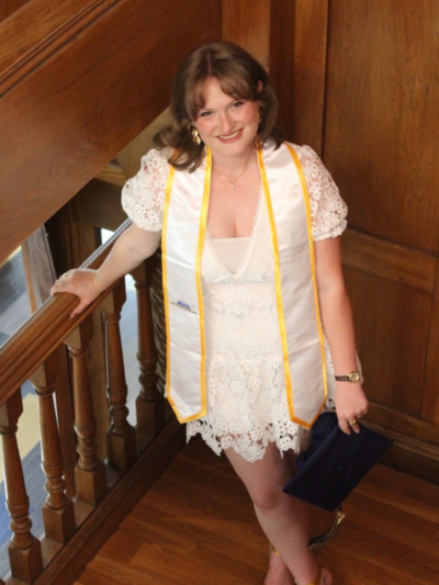 Emma posing in a stairwell looking up at the camera