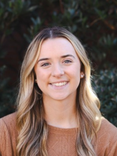 A professional headshot of Taylor