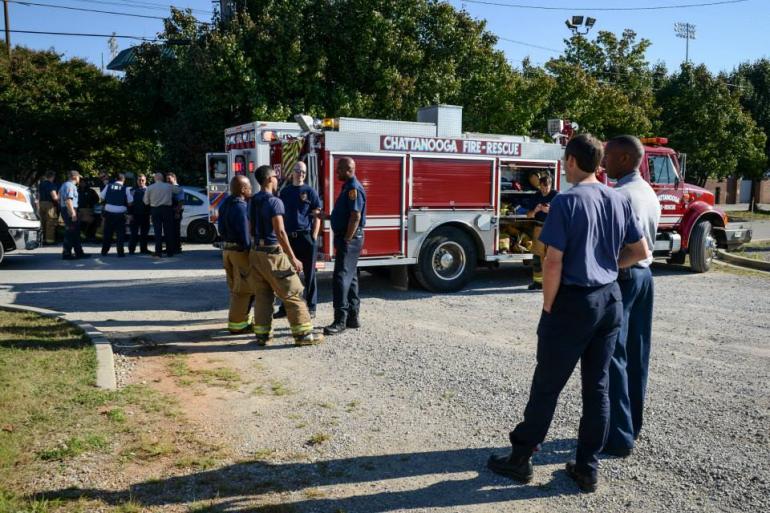 drill 1 firefighters standing next to firetruck