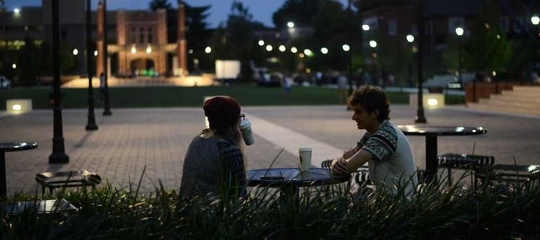 students sitting outside Starbucks on UTC campus at night