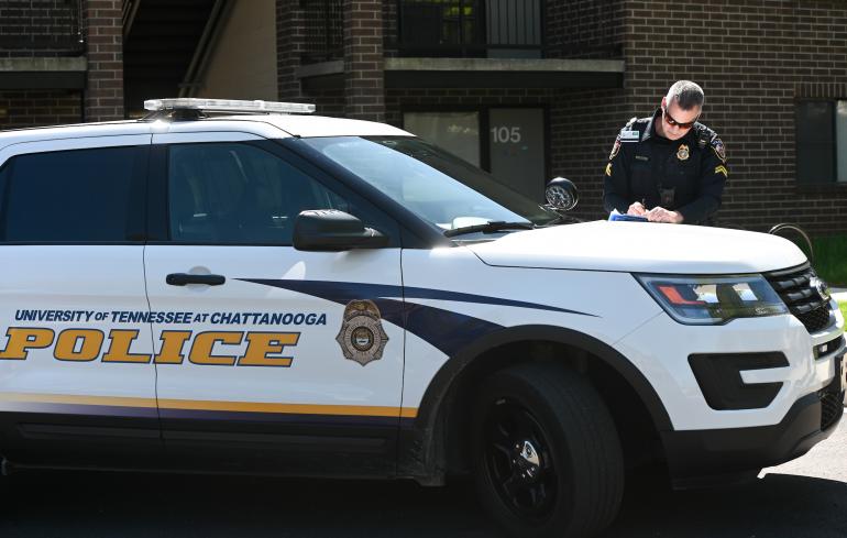 Photo of Police Officer Ross Brenza Writing a Report