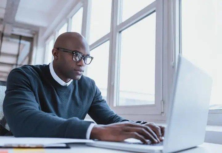 man staring intently at laptop