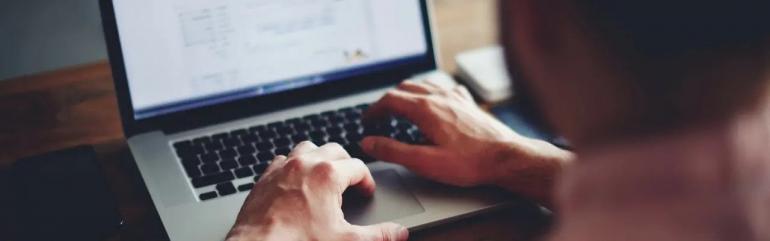 man typing on computer