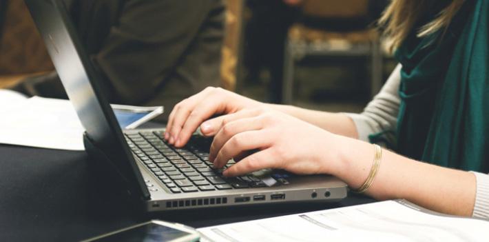 Hands typing on Laptop Keyboard