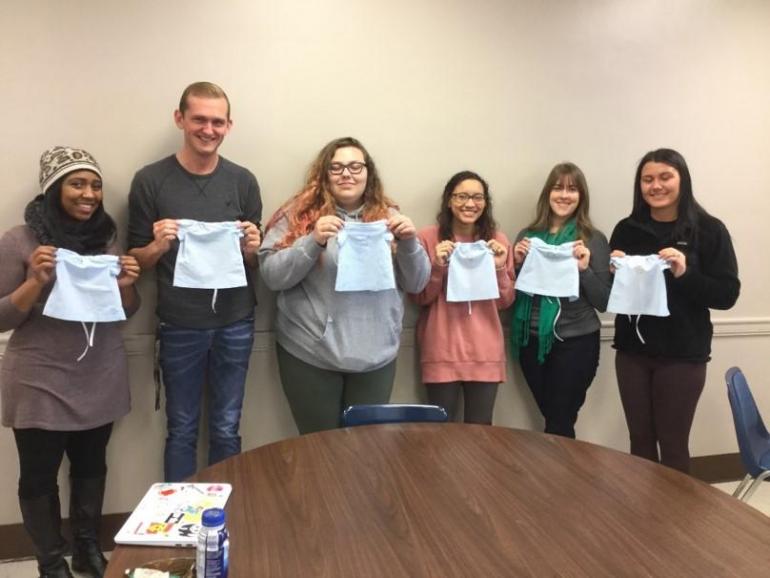 Students holding pictures