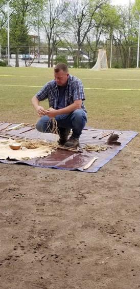 Man uses some of the tools on the ground