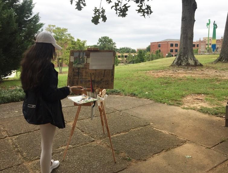 Student painting on Oak Street 