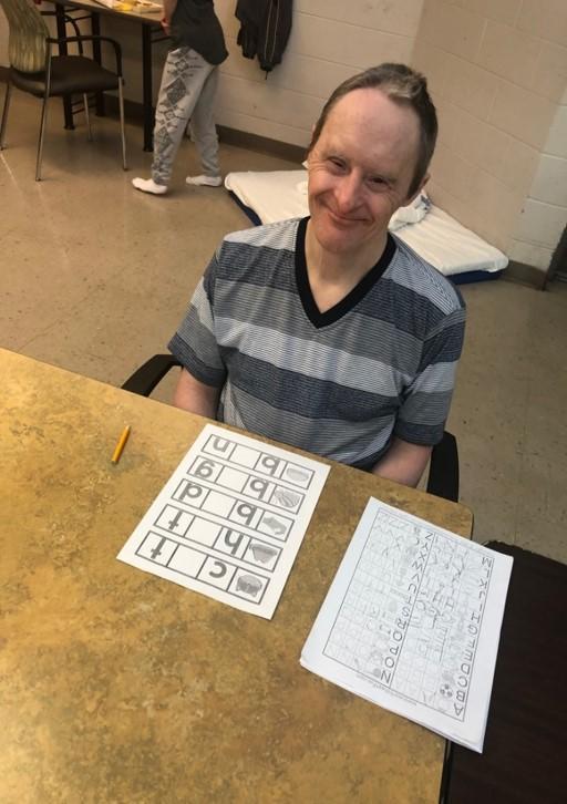 Man sits at table doing activities