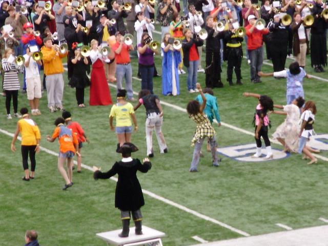 High school students join the band on a football field