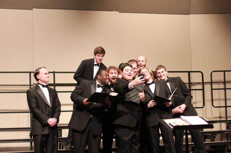 The men's chorus takes a group selfie