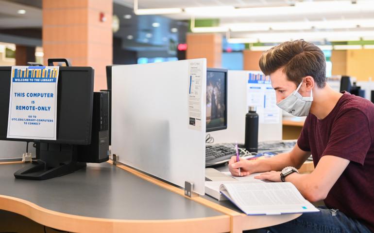student at information commons computer