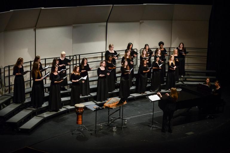 The Women's Chorus sings in a concert