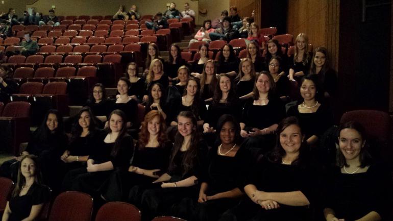 The UTC Women's Chorus sits in an auditorium