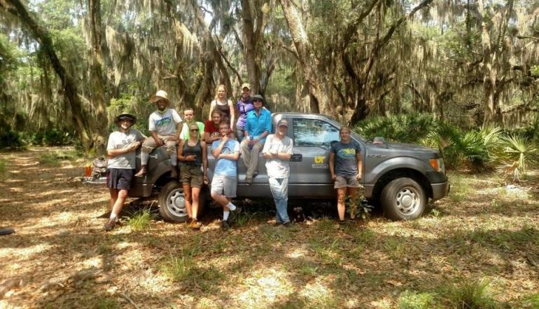 Group picture in front of car