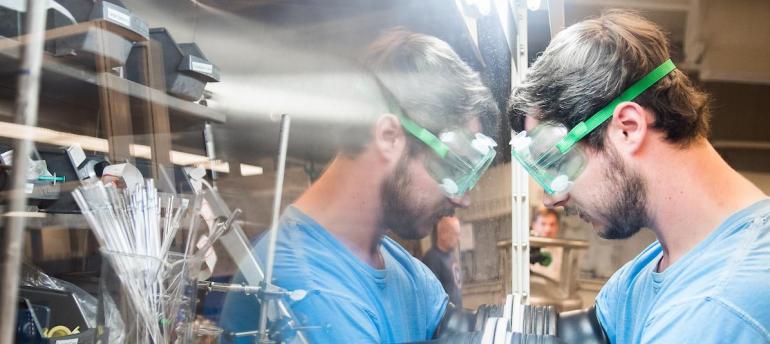 Student with goggles in chem lab