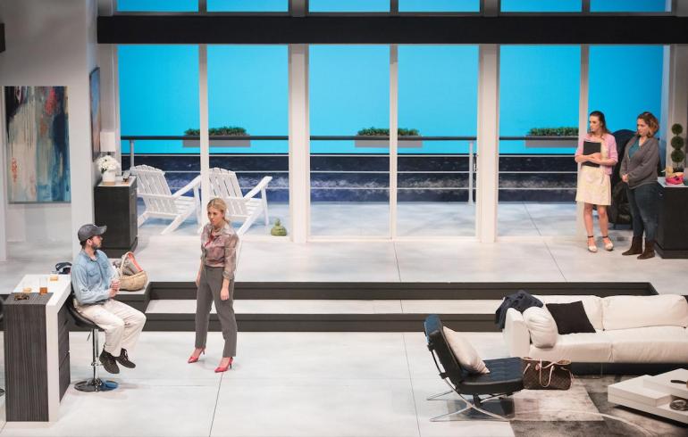 far-away shot of entire set made to look like an expensive home's living room with cast mambers on stage