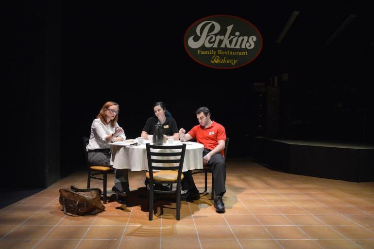 three cast members sit at table with Perkins sign behind them