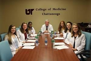 Pre-medical Elective Program Students and professor at table
