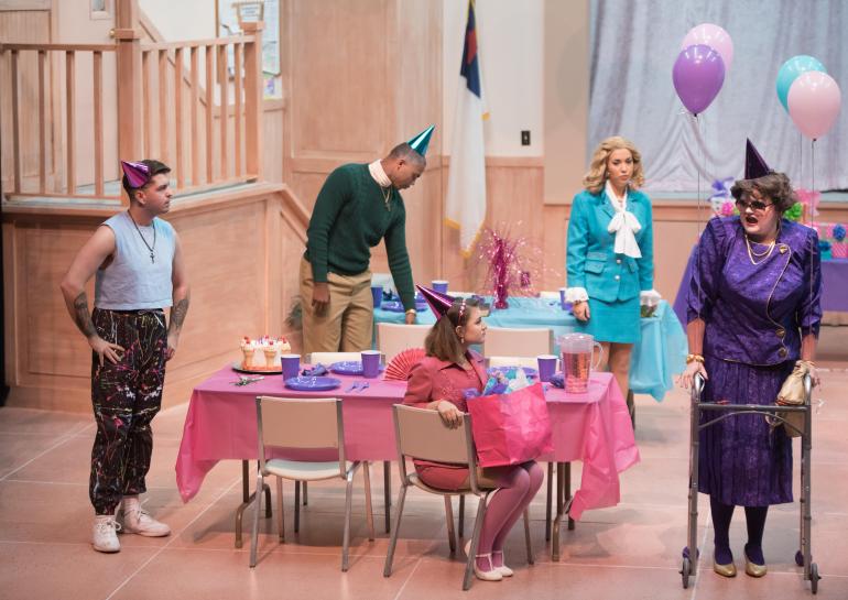 cast members on stage set decorated to look like a party