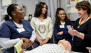 Professor demonstrates with medical lab dummy