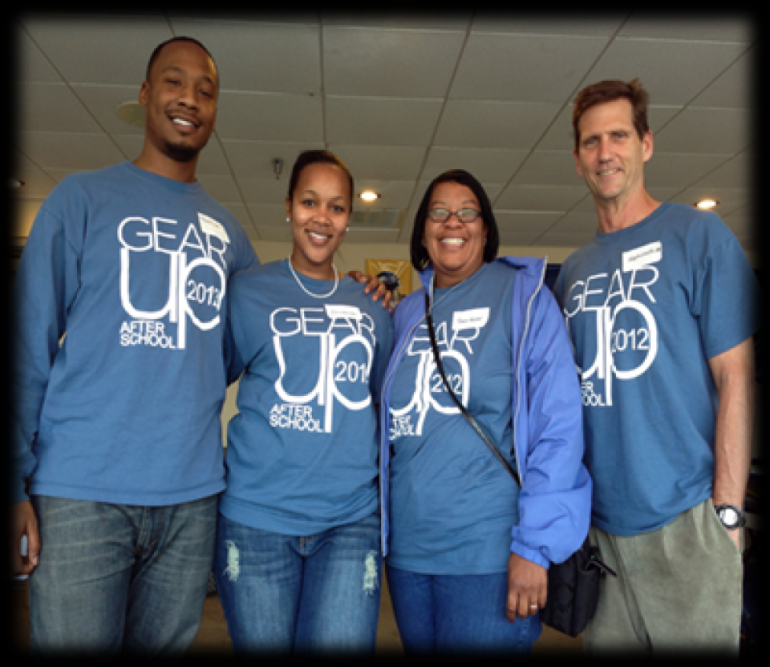 Four individuals in "Gear up" T shirts 