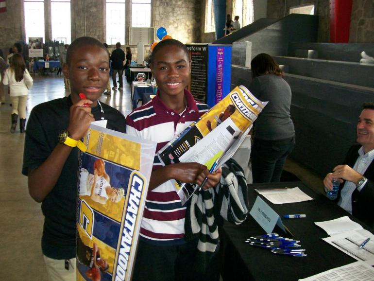 Two Students holding UTC gear